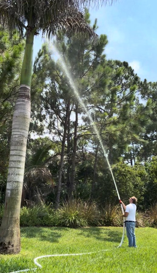 man spraying swimming pool fire hose system powered by existing Jandy 1.85 HP VS Pro Variable Speed pool motor